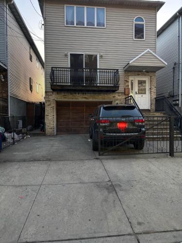 a black car parked in front of a house at Capsule hostel in Newark