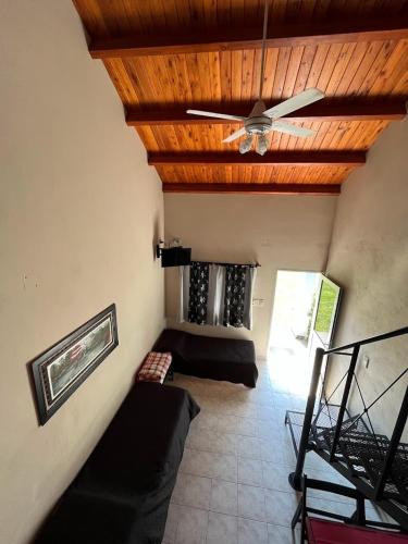 a living room with couches and a ceiling fan at Costa Luna Federacion in Federación