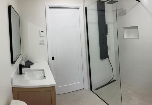 a bathroom with a sink and a glass shower at OBerge in Saint-Raymond