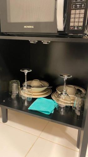 a table with plates and dishes in a microwave at Aloha Noronha Suites in Fernando de Noronha