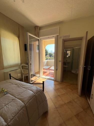 a bedroom with a bed and a door to a patio at Ca' Nadia in Campalto
