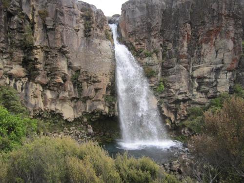 a waterfall on the side of a rocky mountain at Magpie Cottage Homestay Bed & Breakfast in Taumarunui