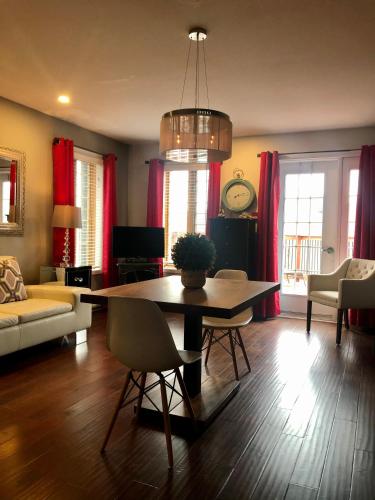 a living room with a table and red curtains at L'intime loft Studio à Orford in Magog-Orford