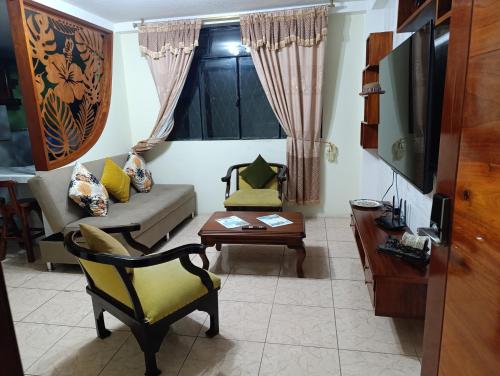 a living room with a couch and a table at Departamento Puyo Fantastic. in Puyo