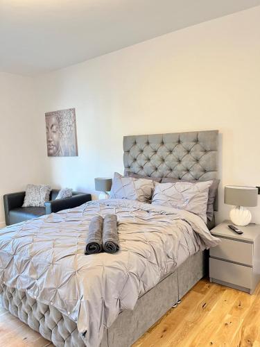 a bedroom with a large bed with shoes on it at luxury apartment in East London in London