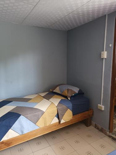 a bedroom with a bed in a room at Gia's Garage & Home for Bocas travelers in Almirante