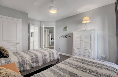 a bedroom with two beds and a dresser at Beachfront 3BDR Condo with Pool & Deck Ocean Views Ocean Blvd #102 by AvantStay in Isle of Palms