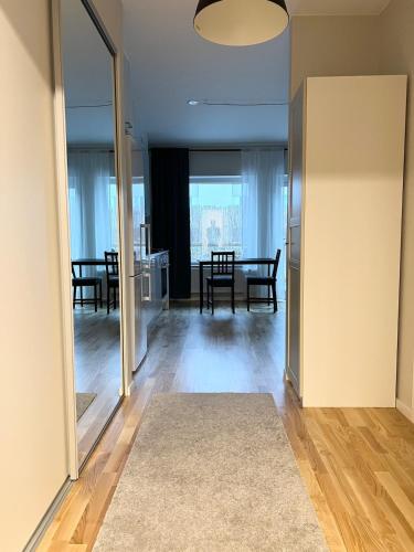 a living room with a table and a dining room at BRAND NEW & Nice Apartment Gothenburg in Gothenburg