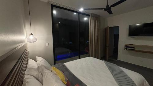 a bedroom with a bed and a large window at Villa Maravilla Estates, Tamarindo Beach, Prime Location, Family & Friends in Tamarindo