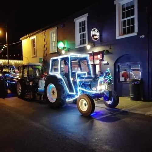 a tractor parked in front of a building at night at Cuckoos Corner in Teach Munna