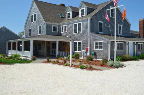 a large house with a flag in the driveway at Beach Breeze Inn in Falmouth