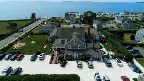 an aerial view of a house with cars parked in a parking lot at Beach Breeze Inn in Falmouth