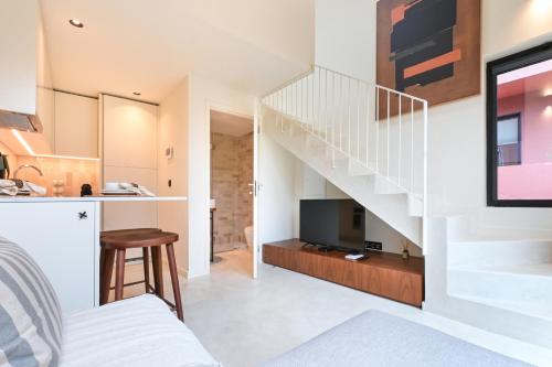 a room with a staircase and a living room at ON Apartments - Cozy - Free Parking & Pet Friendly in Porto