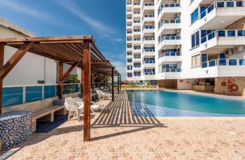a swimming pool next to a large building at Cartagena in Cartagena de Indias