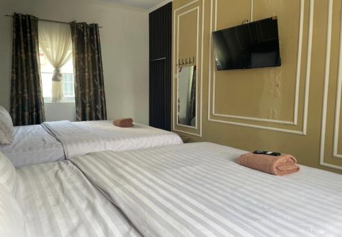 Katil atau katil-katil dalam bilik di Kulon Progo INN Bandara YIA Hotel
