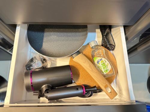 a box with a hair dryer and other items in it at Viraplace1# in Pattaya Central
