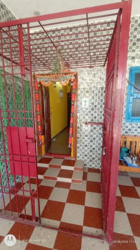 a room with red doors and a checkered floor at Linga Homestay 2BHK Ground Floor in Kanchipuram