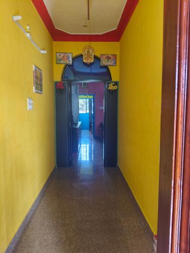 an empty hallway with yellow walls and blue ceilings at Linga Homestay 2BHK Ground Floor in Kanchipuram