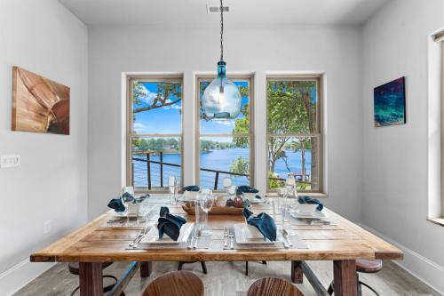 a dining room with a wooden table and windows at Nancy Key in Terrell