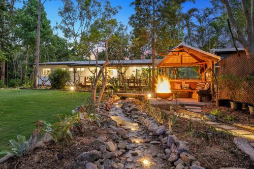a backyard with a gazebo and a fire pit at Tamborine Creek Stay - Fireplace and close to Theme Parks & Mount Tamborine in Wongawallan