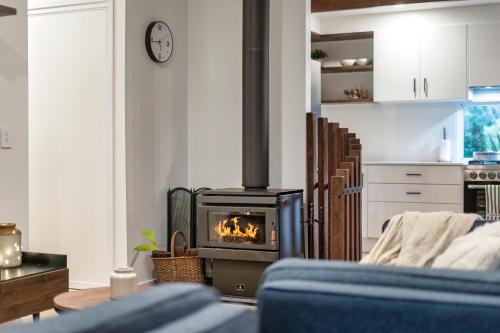 a living room with a stove in a room at Tamborine Creek Stay - Fireplace and close to Theme Parks & Mount Tamborine in Wongawallan