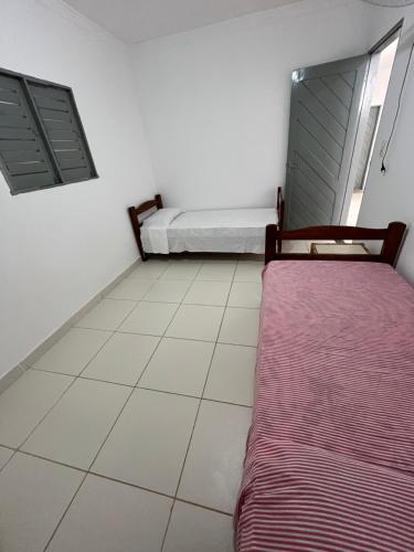 una camera da letto con un letto e un pavimento piastrellato di Apto NOVO MEL ad Areia Branca