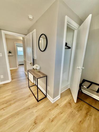 an empty living room with a table and a mirror at Davenport Dwellings-Midtown 3Bed in Omaha