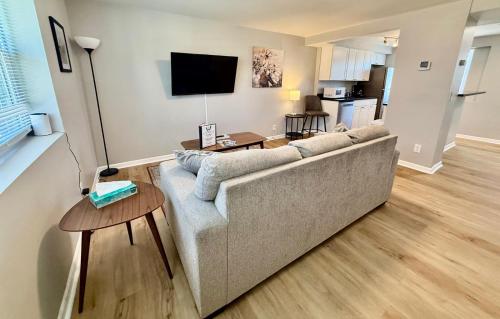 a living room with a couch and a table at Davenport Dwellings-Midtown 3Bed in Omaha