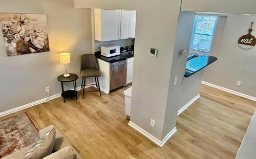 a living room with a couch and a kitchen at Davenport Dwellings-Midtown 3Bed in Omaha