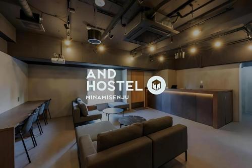 a living room with a couch and a bar at &AND HOSTEL MINAMISENJU in Tokyo