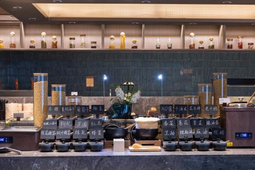 a store with a bunch of food on a counter at Atour Hotel Canton Tower Pearl River Binjiang Road East Guangzhou - Free Shuttle Bus Service Between Fair And Hotel During The Canton Fair in Guangzhou