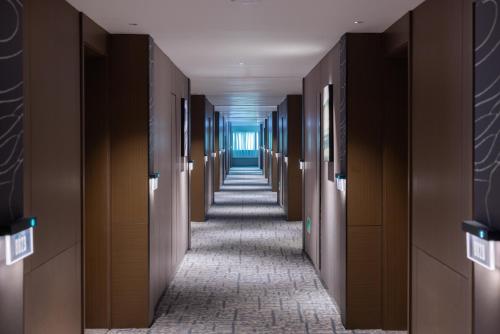 a hallway in a building with a hallway at Atour Hotel Canton Tower Pearl River Binjiang Road East Guangzhou - Free Shuttle Bus Service Between Fair And Hotel During The Canton Fair in Guangzhou