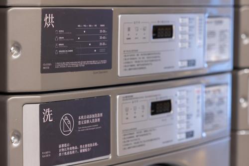 a row of microwaves sitting next to each other at Atour Hotel Canton Tower Pearl River Binjiang Road East Guangzhou - Free Shuttle Bus Service Between Fair And Hotel During The Canton Fair in Guangzhou