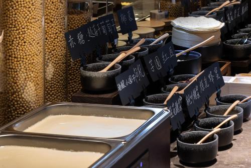 a counter with bowls of milk and wooden spoons at Atour Hotel Canton Tower Pearl River Binjiang Road East Guangzhou - Free Shuttle Bus Service Between Fair And Hotel During The Canton Fair in Guangzhou