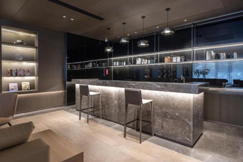 a bar in a restaurant with two stools at Atour Hotel Canton Tower Pearl River Binjiang Road East Guangzhou - Free Shuttle Bus Service Between Fair And Hotel During The Canton Fair in Guangzhou