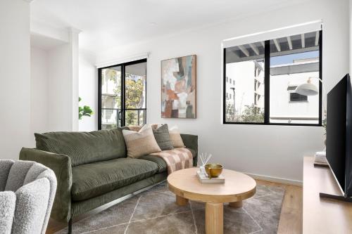 a living room with a couch and a table at Stafford St Apartments by Urban Rest in Adelaide