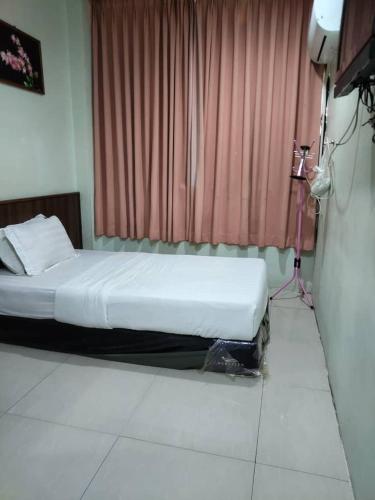 Cama o camas de una habitación en T Lodge, Kapit