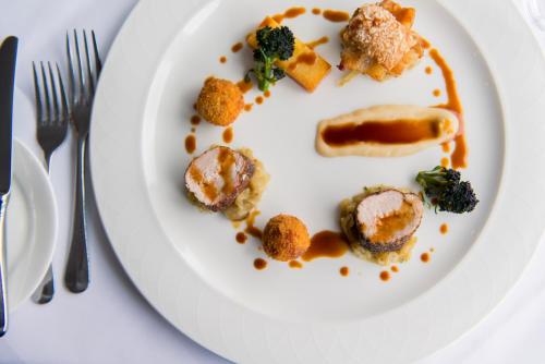 a white plate with food on a table at Lake Vyrnwy Hotel & Spa in Llanwddyn