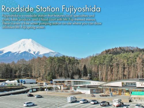 a parking lot with a snow covered mountain in the background at HOTEL MYSTAYS Fuji Onsen Resort in Fujiyoshida