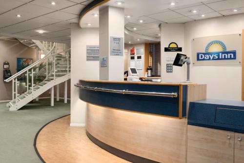 a day inn lobby with a counter and stairs at Days Inn by Wyndham Donington in Castle Donington