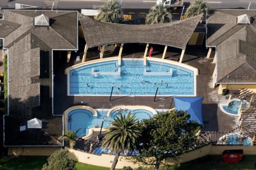 an overhead view of a house with a swimming pool at Oceanside Bliss - Absolute Beachfront - Uninterrupted Ocean Views with Pool in Mount Maunganui