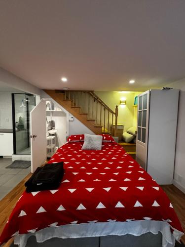 a large red bed in a room with a staircase at Riad Sang Neuf in Quebec City