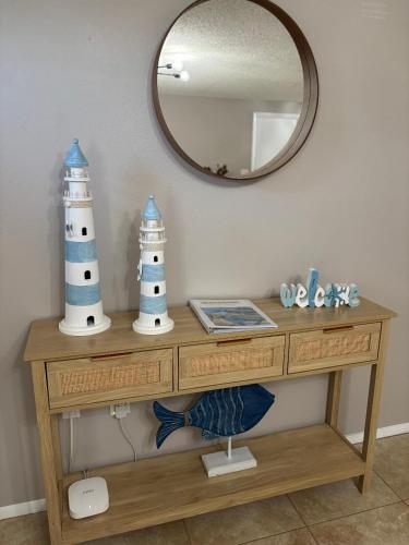 a table with two lighthouses on it with a mirror at Coastal Oasis 64th in Bradenton