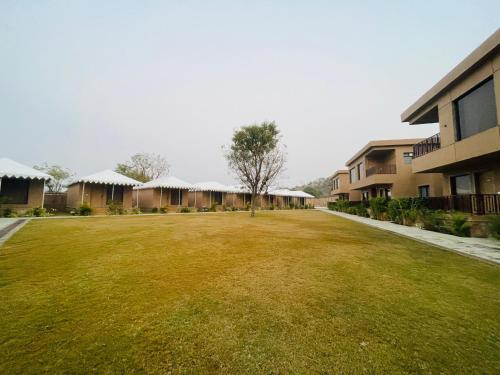 a large grass field in front of a building at Imperia Resort by The Sky Imperial, Nathdwara in Nāthdwāra