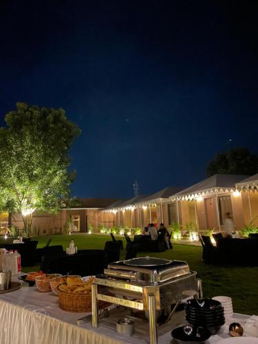 a table with food on it at night at Imperia Resort by The Sky Imperial, Nathdwara in Nāthdwāra