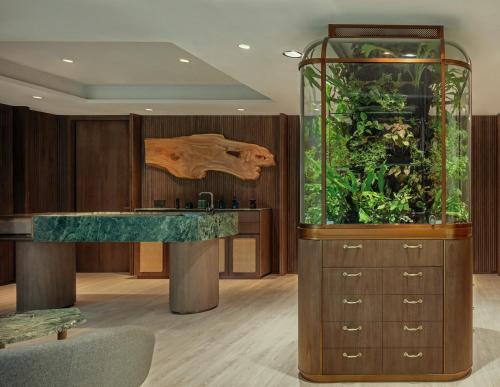 a large aquarium with a fish tank in a room at Mandai Rainforest Resort by Banyan Tree in Singapore