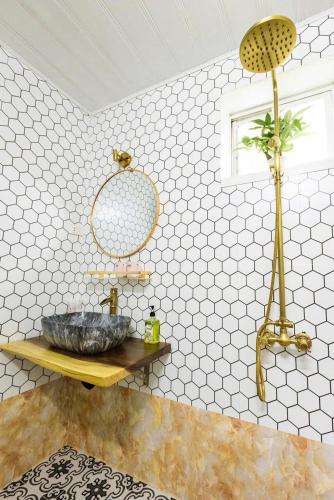 a bathroom with a large stone sink on a table at Charm Home 2 in Hanoi