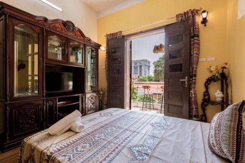 a bedroom with a large bed and a large window at Charm Home 2 in Hanoi