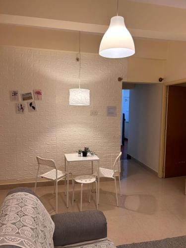 a living room with a table and chairs and a couch at Electrifying 2 BHK Getaway in Bengaluru