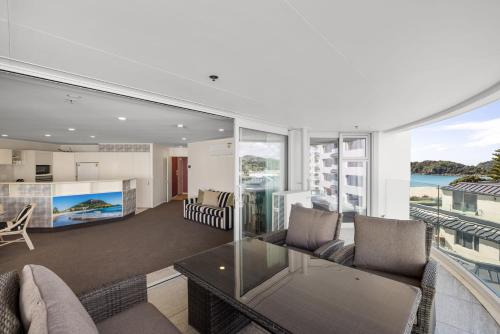 an open living room with a view of the ocean at A Strand of Paradise, Oceanside Views & Pool in Mount Maunganui